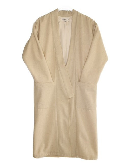 Front product view of the cream wool kimono with an open front, wide sleeves, and two oversized patch pockets.