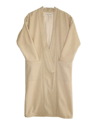 Front product view of the cream wool kimono with an open front, wide sleeves, and two oversized patch pockets.
