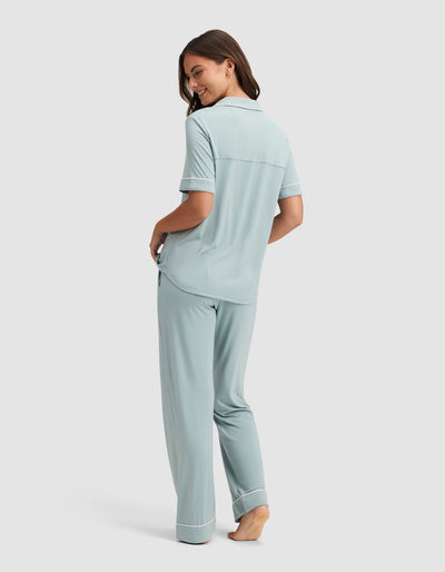 Back view of the pale blue pajama set, showing the top’s horizontal back seam, short sleeves, and loose full-length pants.