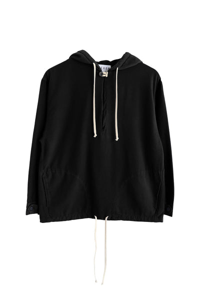 Front product view of the black Anorak with white hood and hem drawcords.