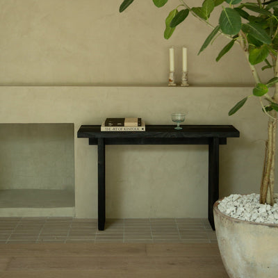 Black Shou Sugi Ban console table styled with books and candles