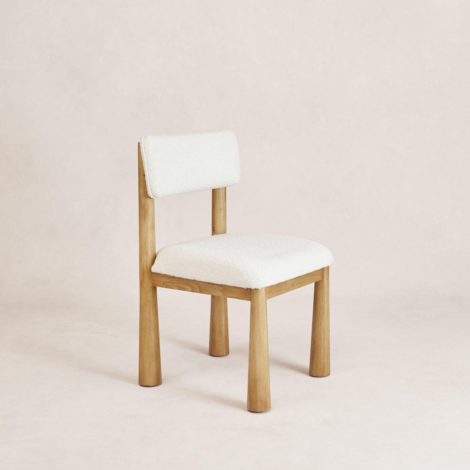 Charlie dining chair in white oak with bouclé upholstery, front angled view