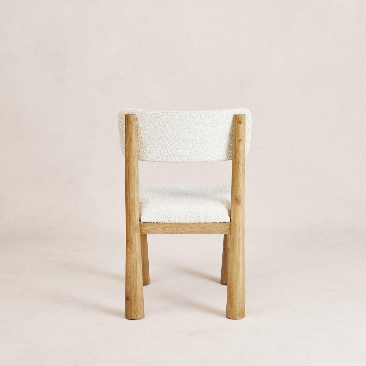 Charlie dining chair in white oak with bouclé upholstery, rear view