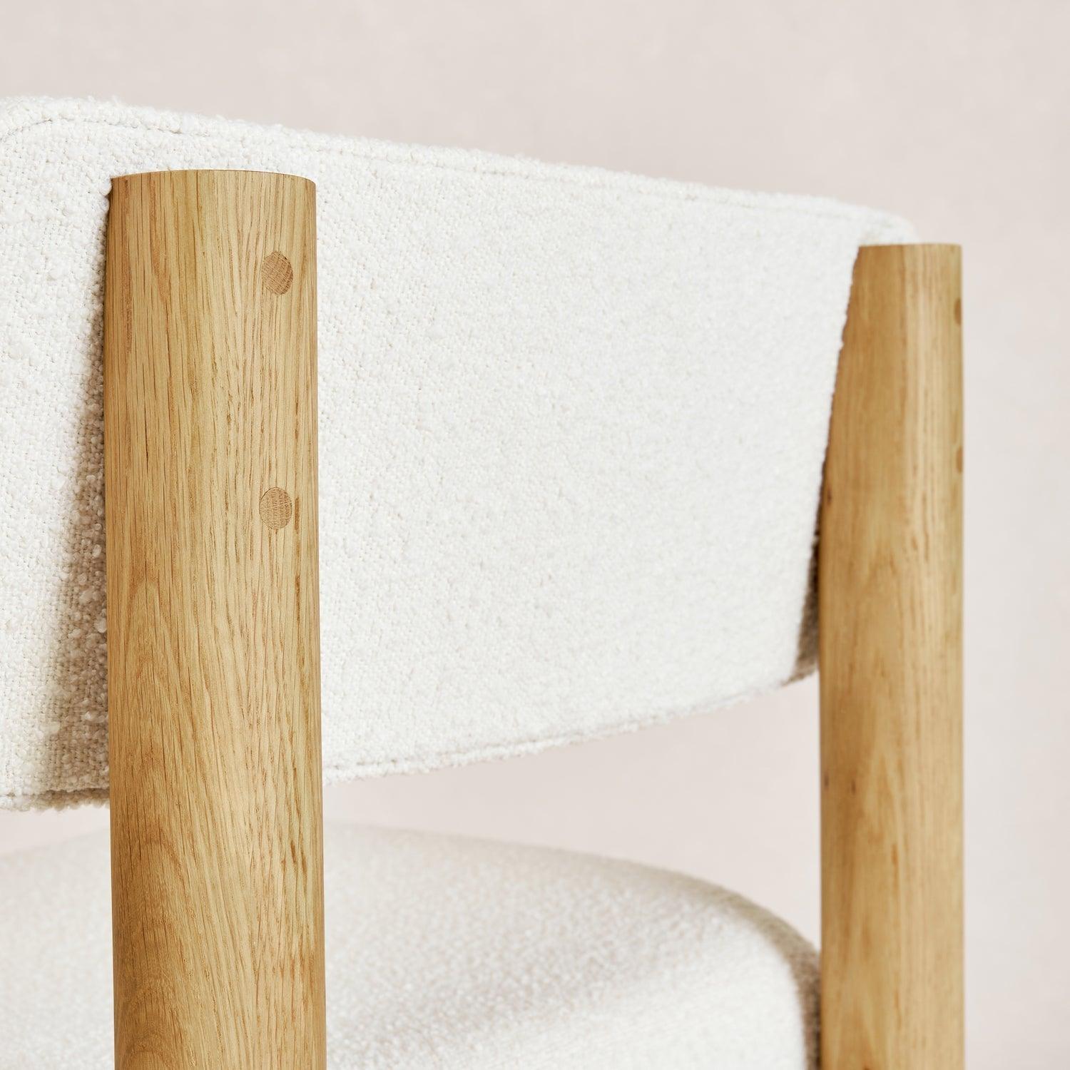 Charlie dining chair backrest detail in white oak and bouclé upholstery