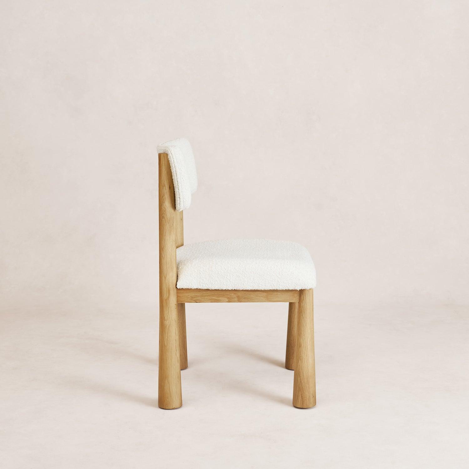 Charlie dining chair in white oak with bouclé upholstery, side view