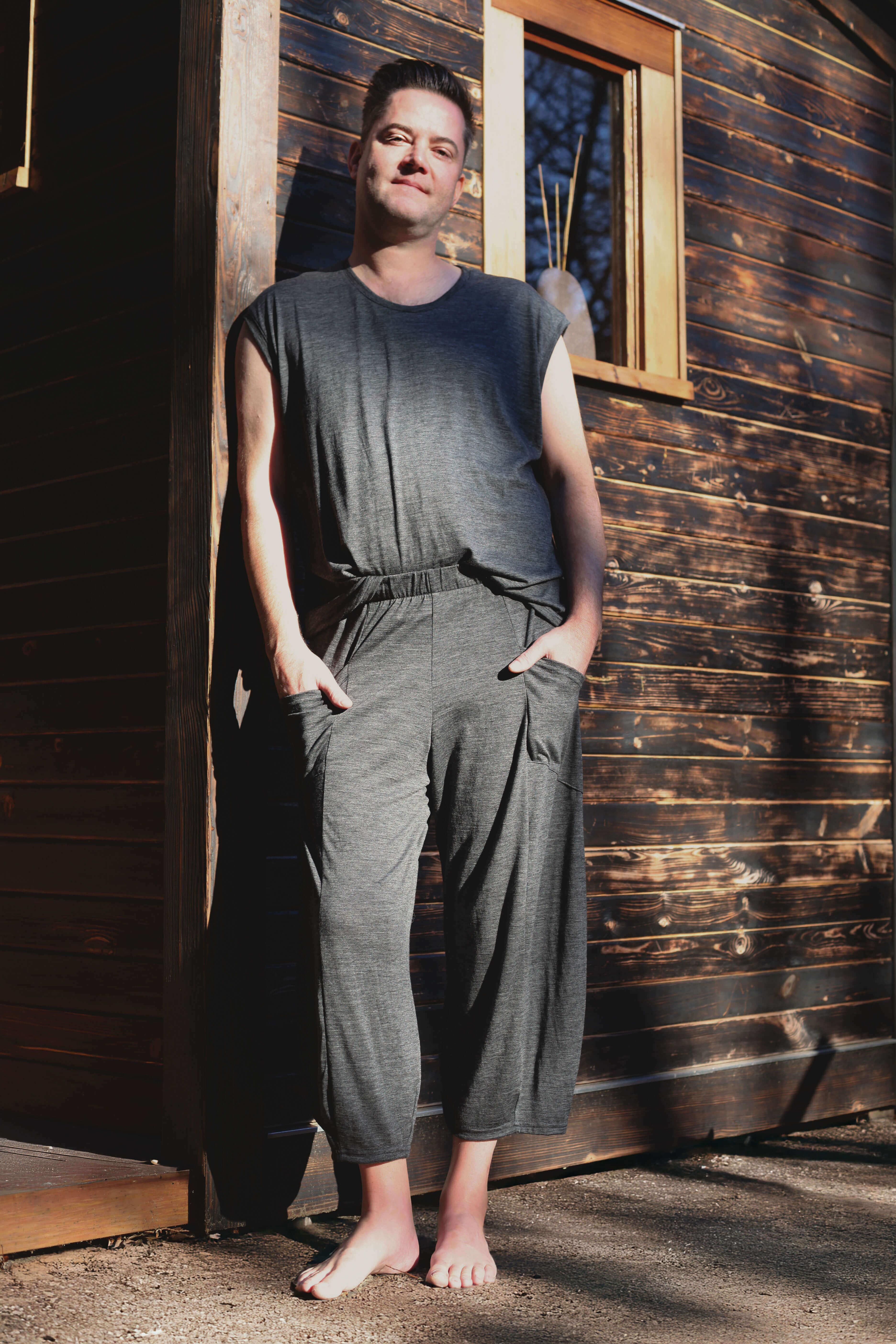 Man wearing merino wool lounge pants outside a sauna, combining natural comfort, temperature regulation, and minimalist style.