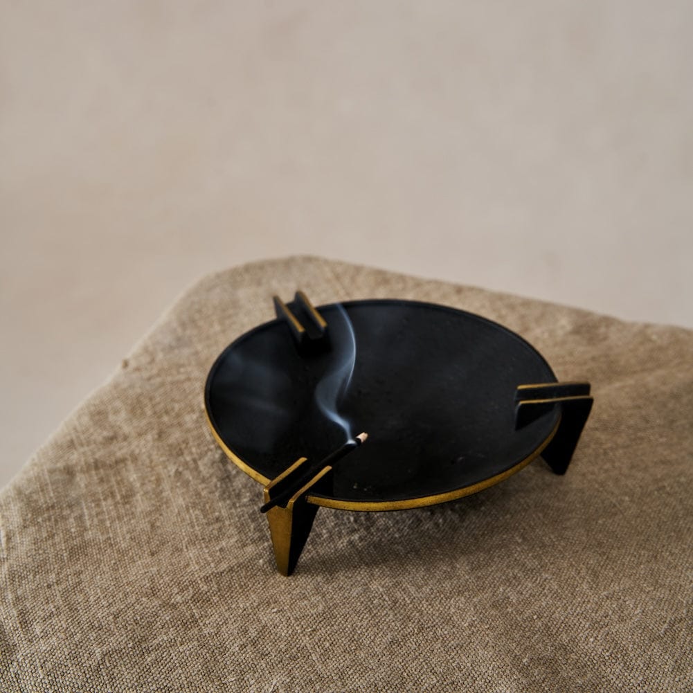 A vintage-inspired Milan Ashtray crafted from solid brass with a sleek black patina, displayed on a neutral background.