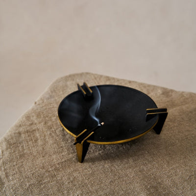 A vintage-inspired Milan Ashtray crafted from solid brass with a sleek black patina, displayed on a neutral background.