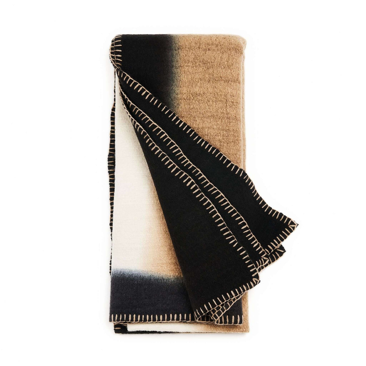 Ink Black and White merino throw folded vertically to display its contrasting color blocks and hand-stitched edges