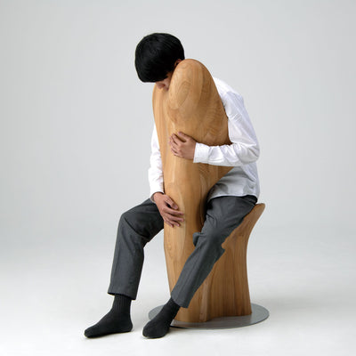 Person embracing HUG Chair by CondeHouse demonstrating sculptural hugging form