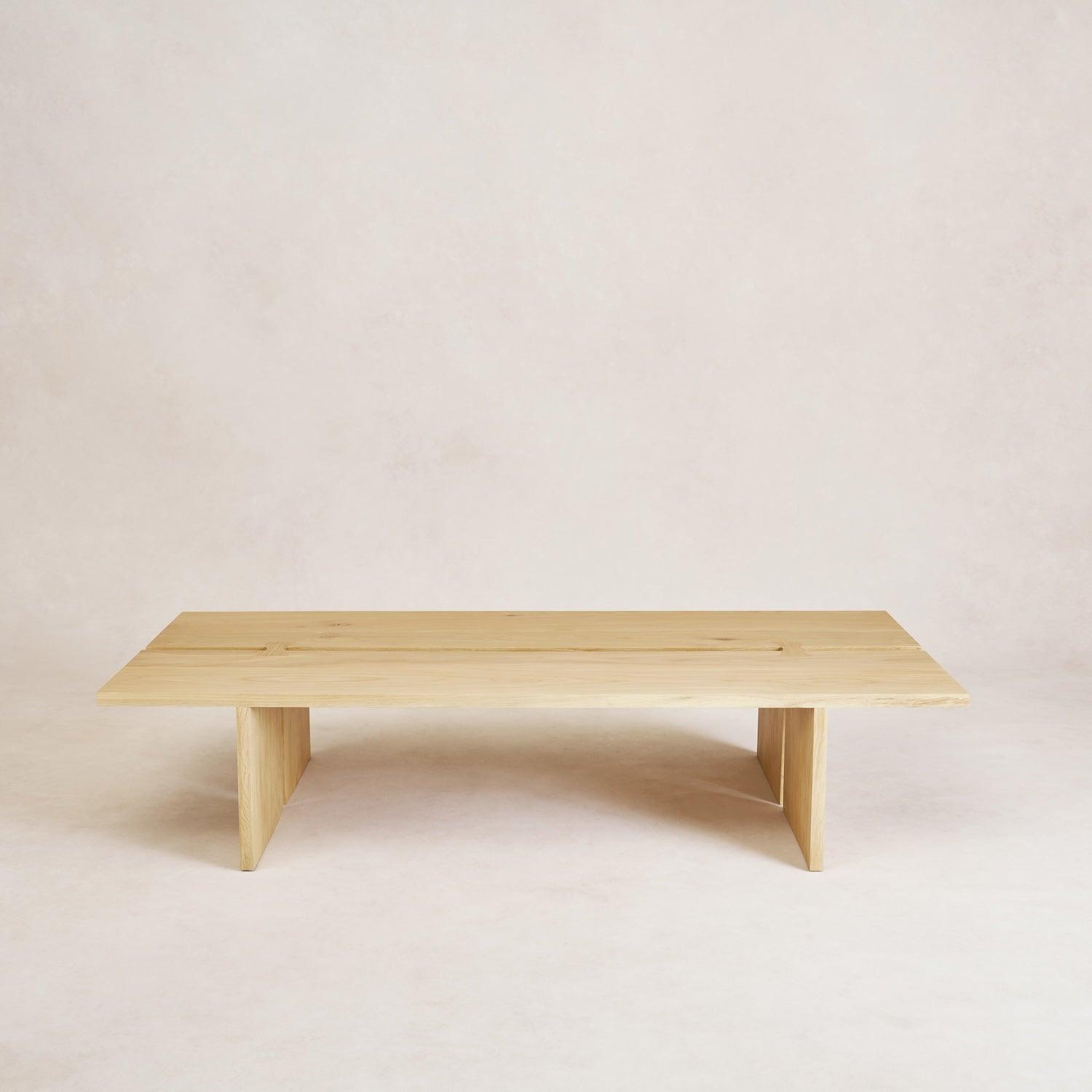 A minimalist natural wood Kyoto Coffee Table with butterfly joints on a plain background.