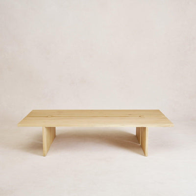 A minimalist natural wood Kyoto Coffee Table with butterfly joints on a plain background.