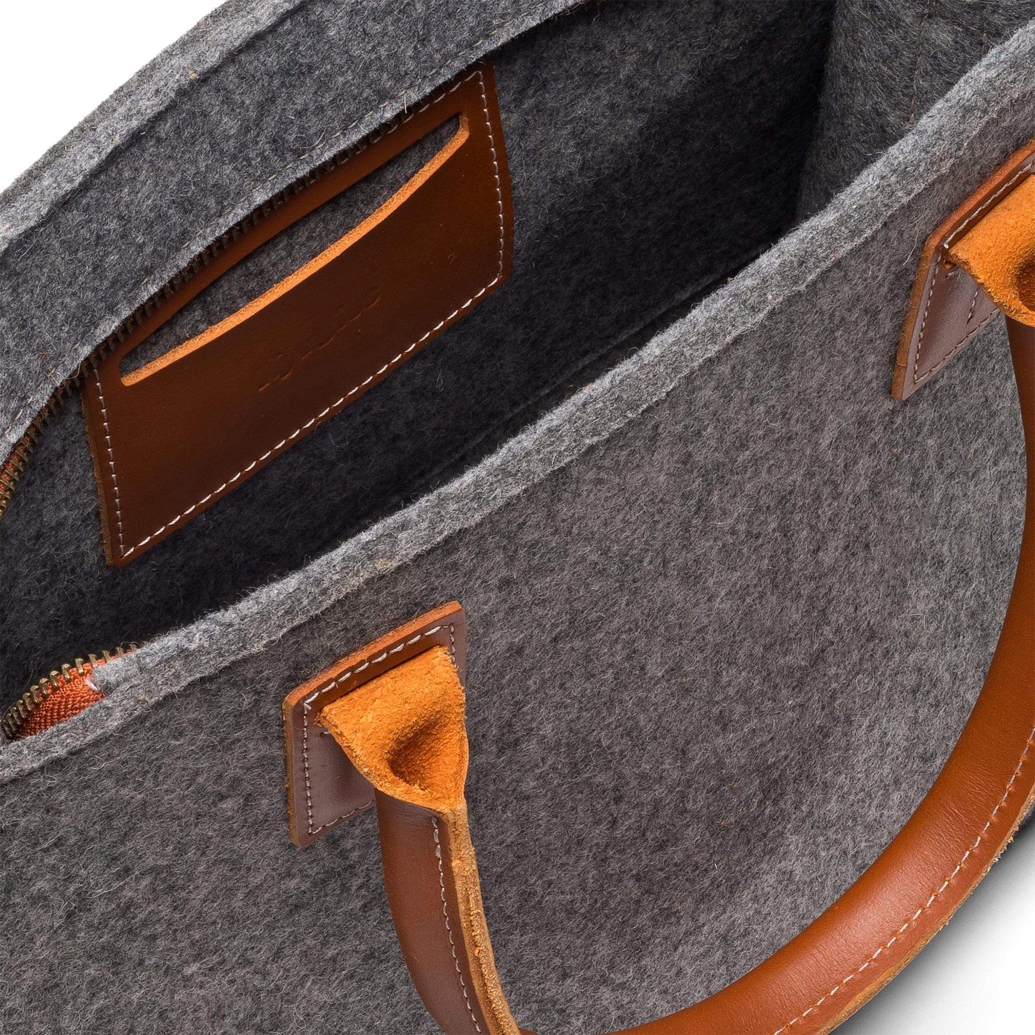 Interior of Kyrgies wool handbag featuring soft wool felt lining and storage pocket