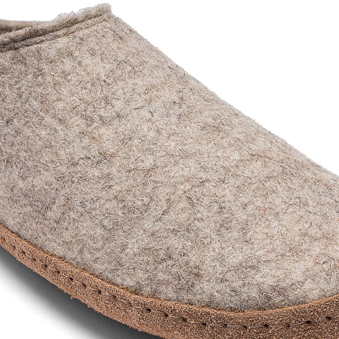 Kyrgies Indoor Wool Slides, oatmeal wool felt, close-up side view showing heel and sole stitching