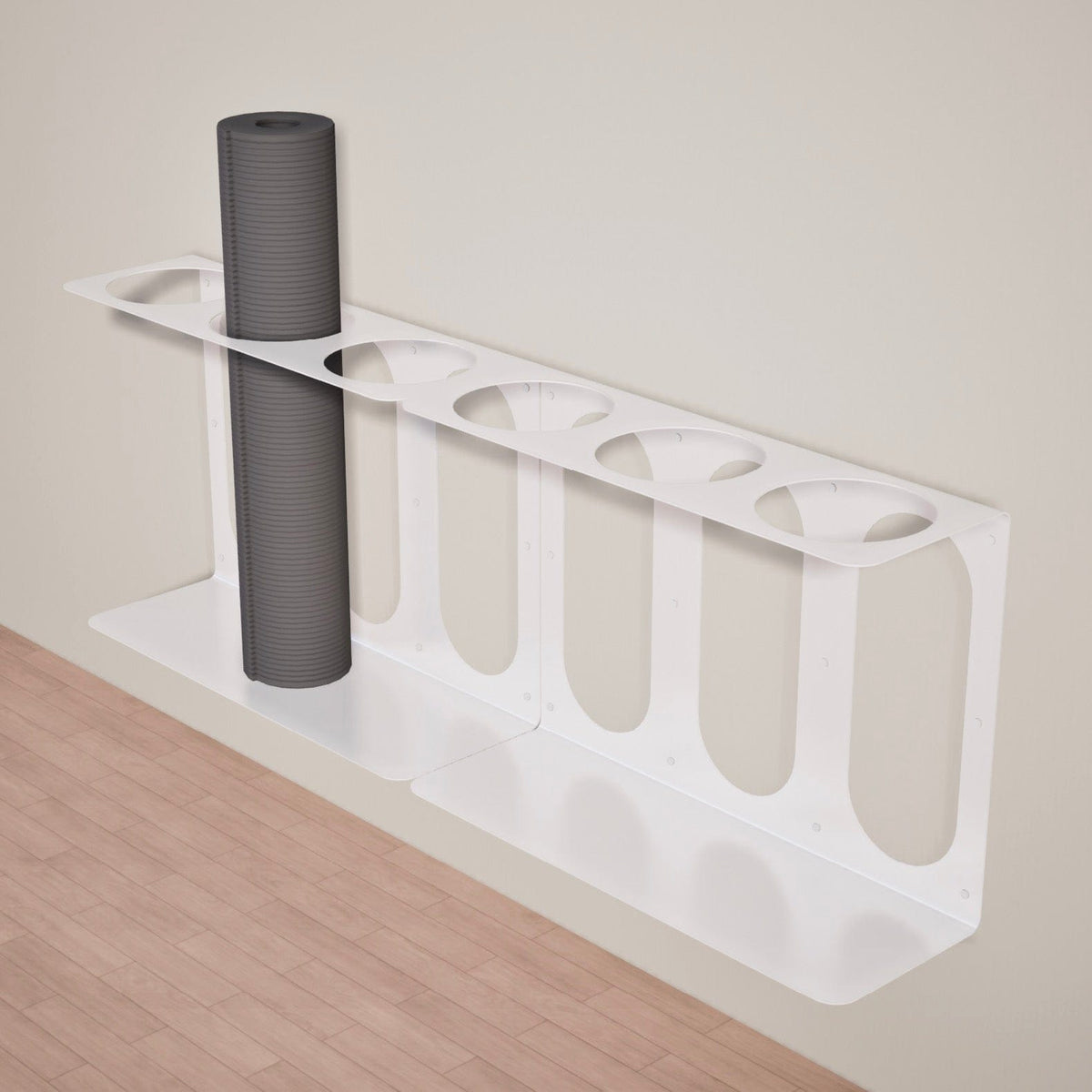White metal bracket holding one dark gray roller, showing its circular top openings, elongated oval cutouts, and lower support shelf.