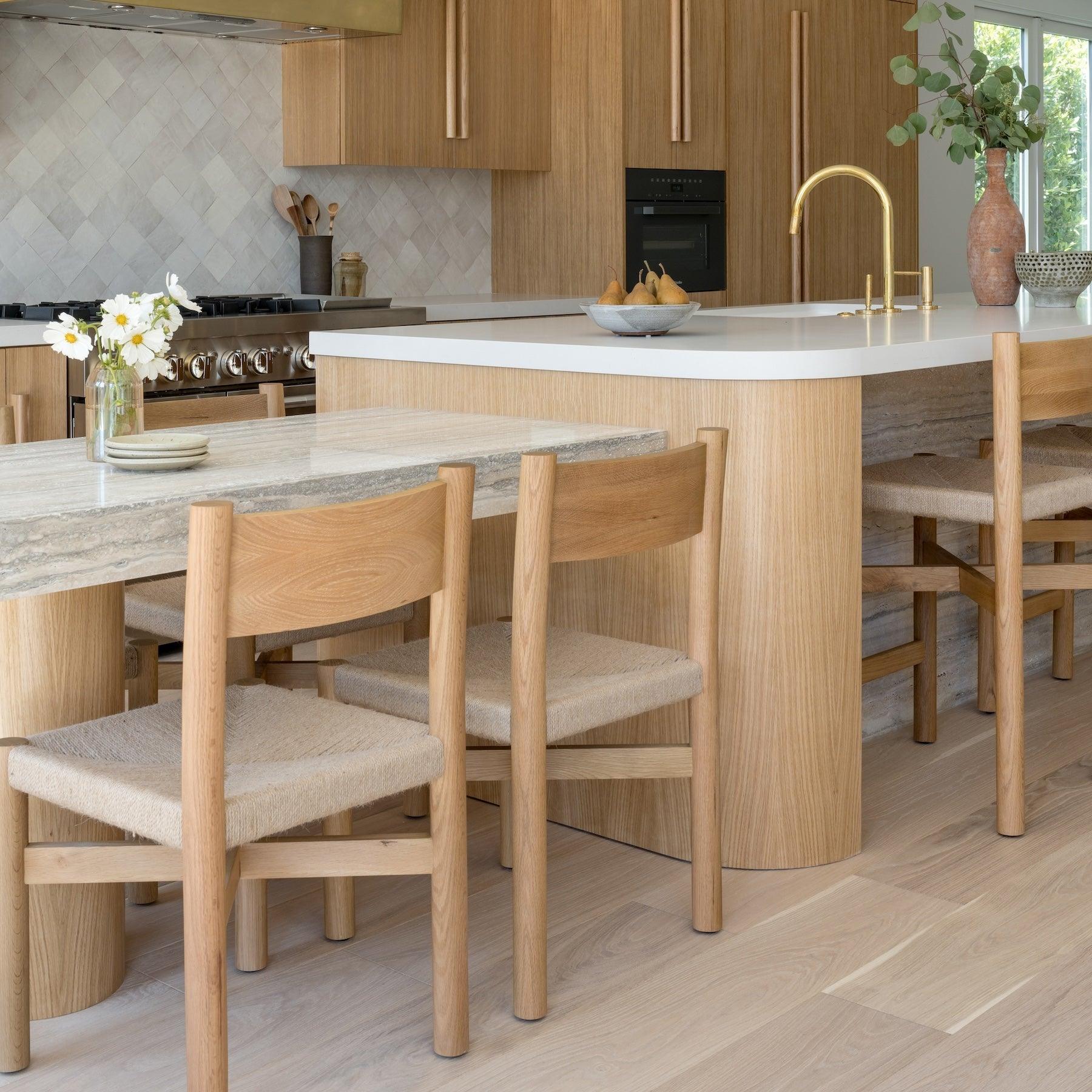 Minimalist dining space with woven jute dining chairs in warm oak