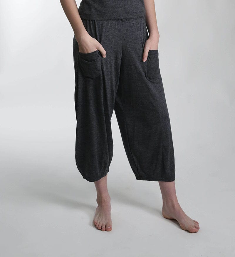 Full-length view of charcoal merino wool lounge pants featuring a relaxed silhouette for recovery, travel, and everyday wear.