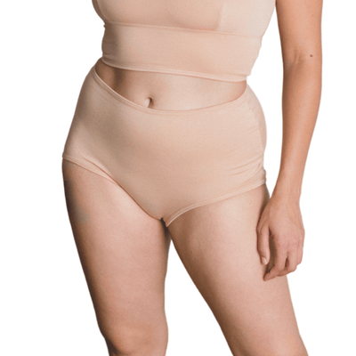 Model wearing Organic Cotton High-Rise Brief in Ada Nude, side view