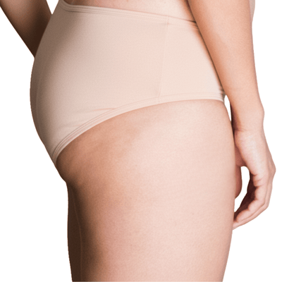 Model wearing Organic Cotton Mid-Rise Brief in Ada Nude, side view
