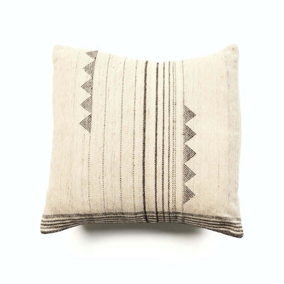 Front view of the ivory Kora pillow with vertical black stripes and triangular side motifs.