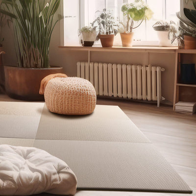 A tatami mat in a room with a window overlooking a well-planted interior space, showcasing its use as a floor covering for activities such as yoga or as a decorative item.
