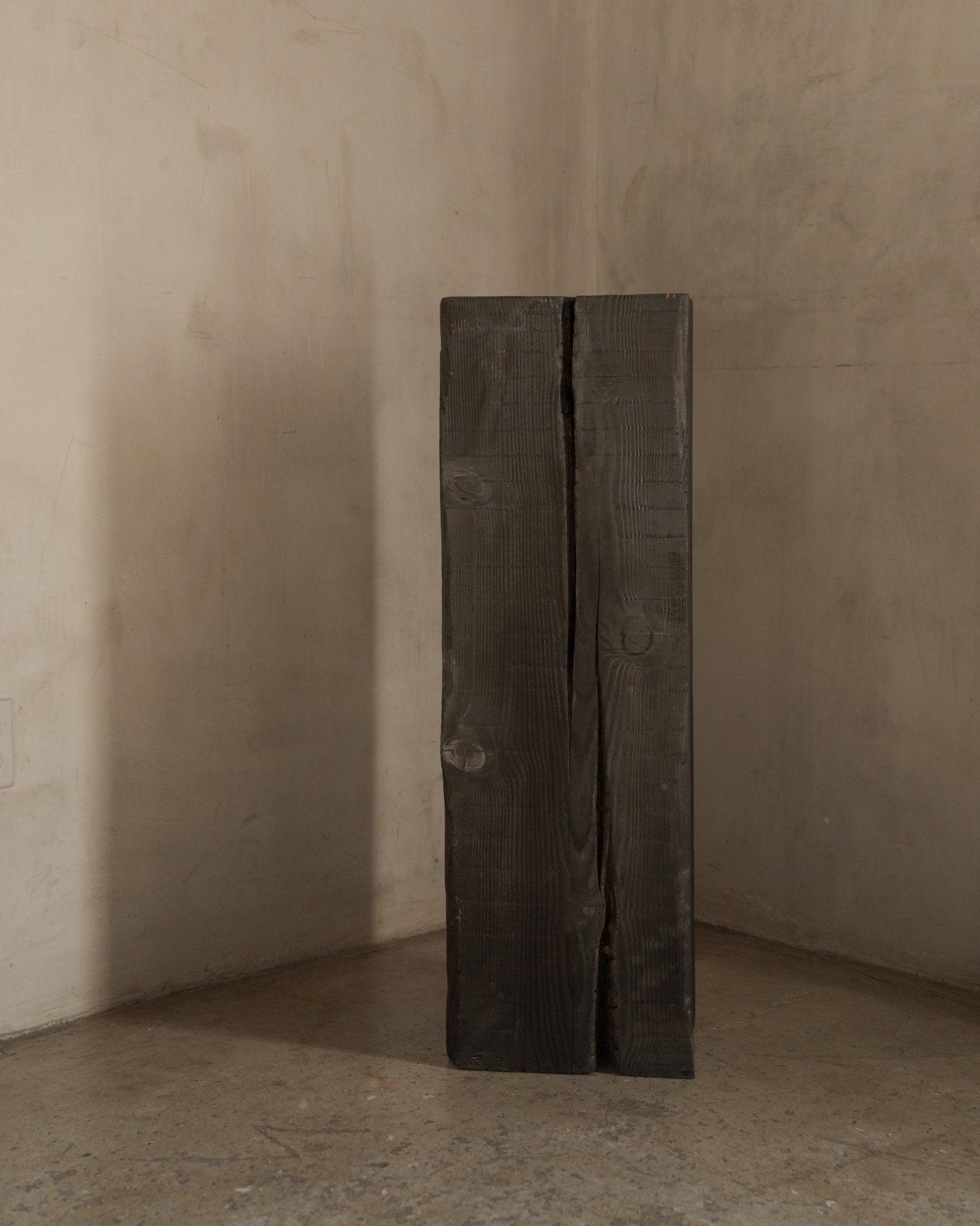 Charcoal sculpture pedestal in solid Douglas fir, angled studio view
