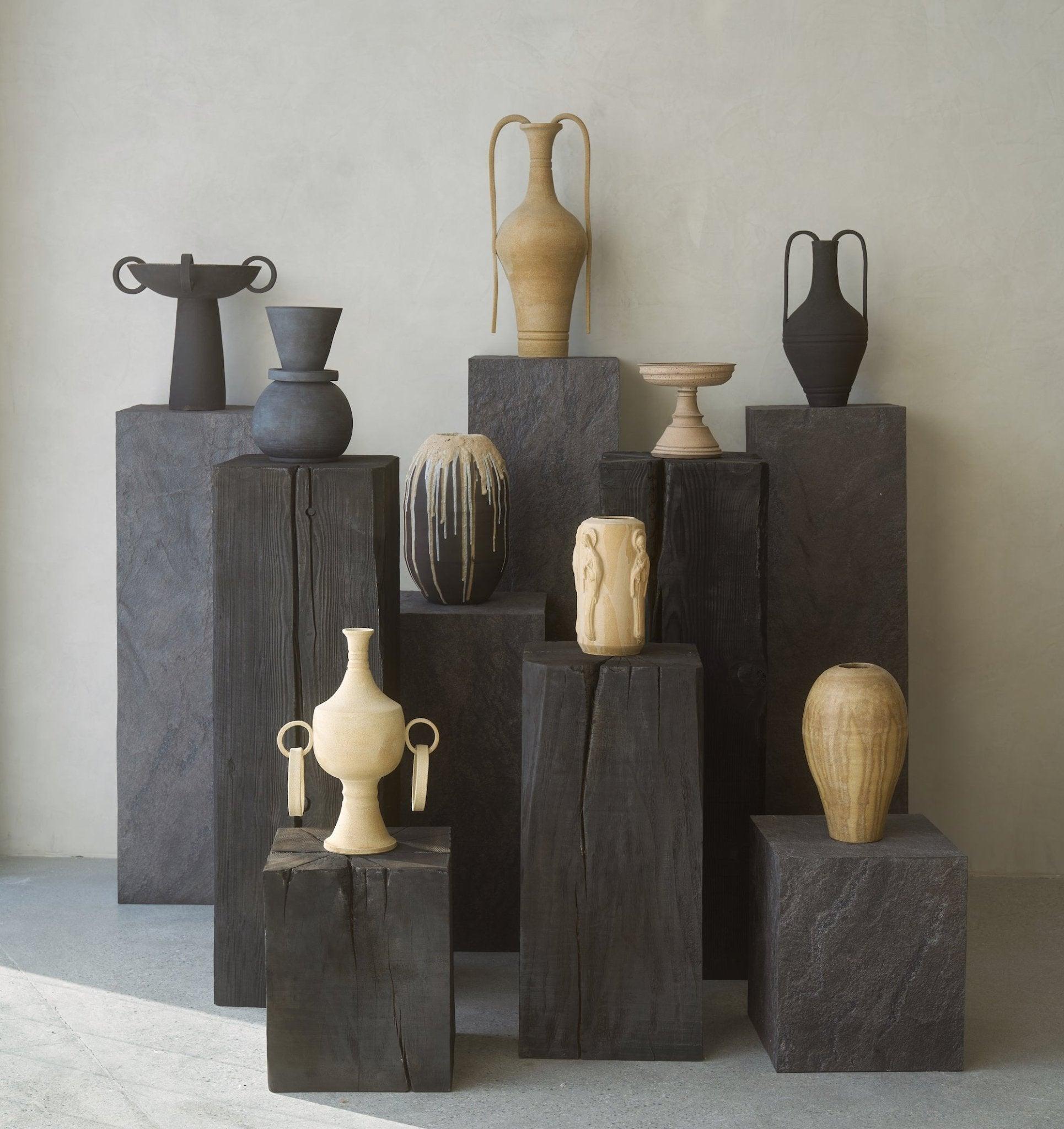 Charcoal sculpture pedestal collection in varying heights, sculptural display