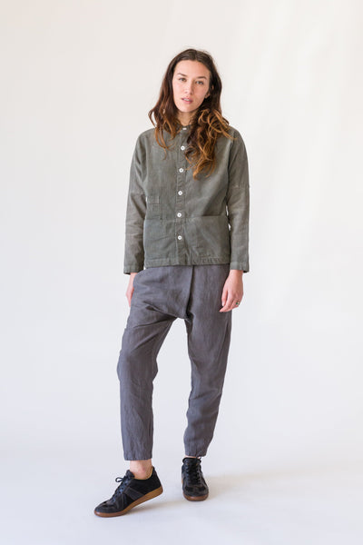 Full-length view of a model wearing a charcoal Raj coat with gray cropped pants and black shoes.