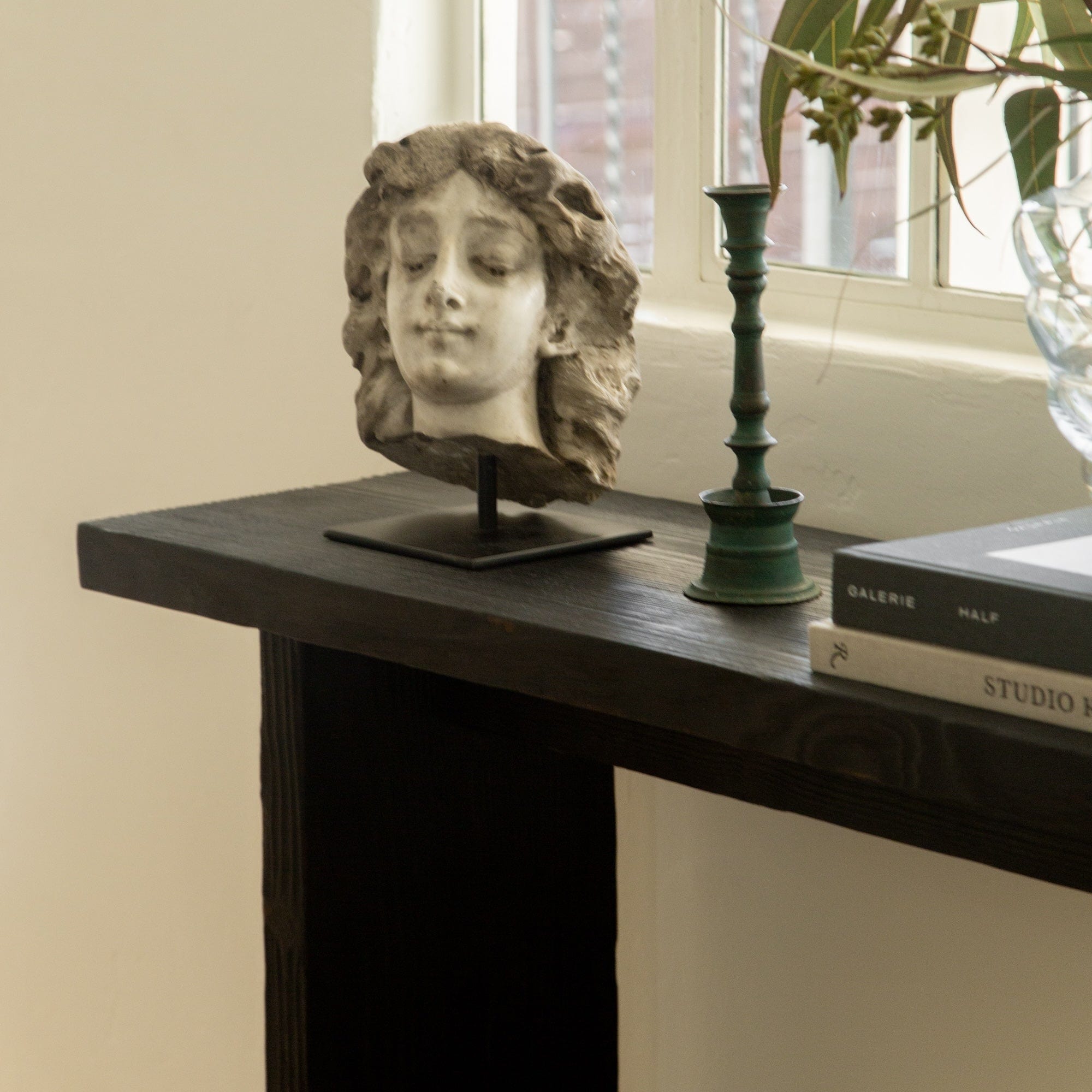 Japandi entryway styled with Shou Sugi Ban console and indoor plant