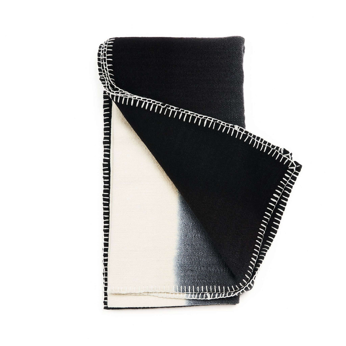 Variously Siro Brown merino throw folded upright to display its bold black, cream and tan color blocking