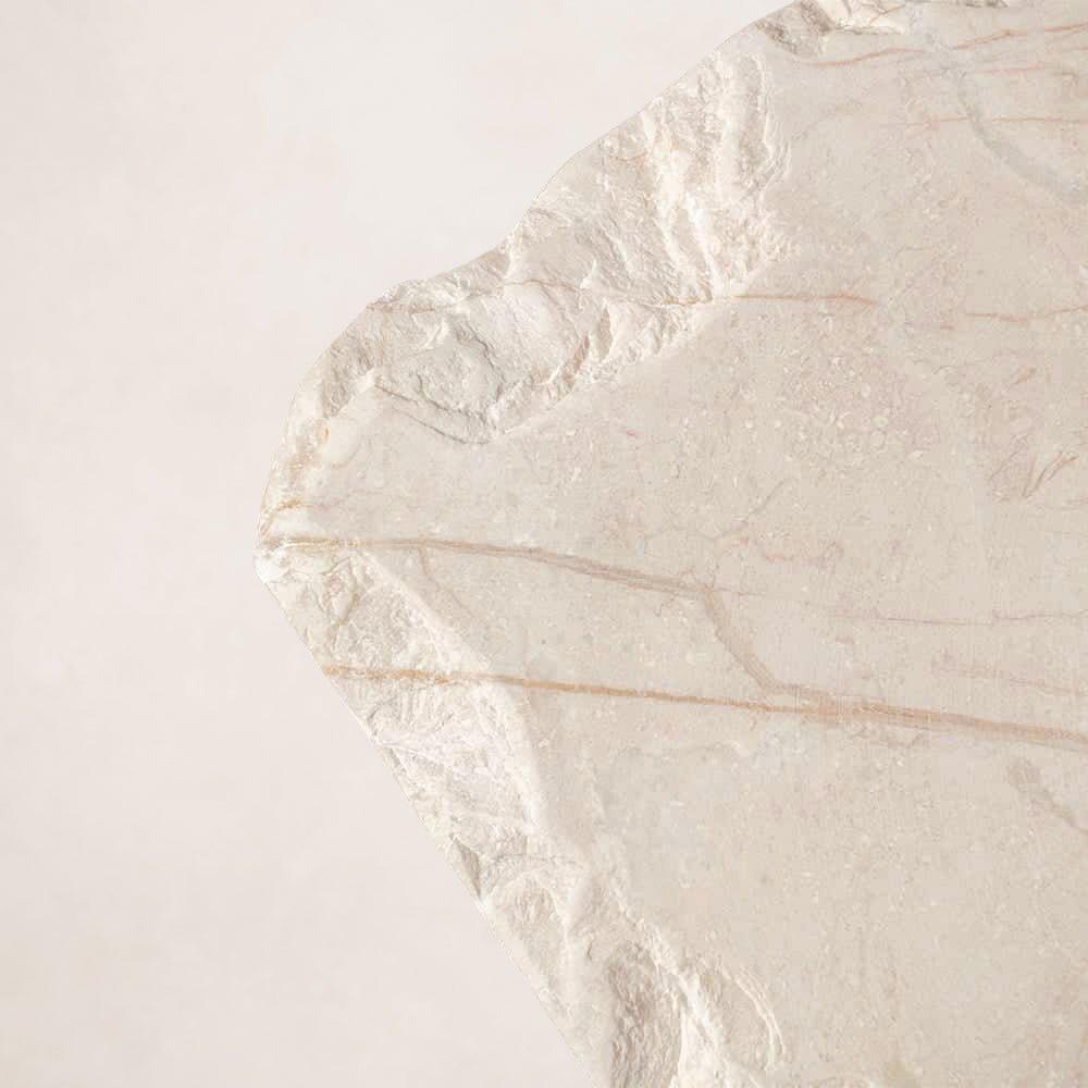 Hand-chipped edge detail on handcrafted Sofita marble coffee table