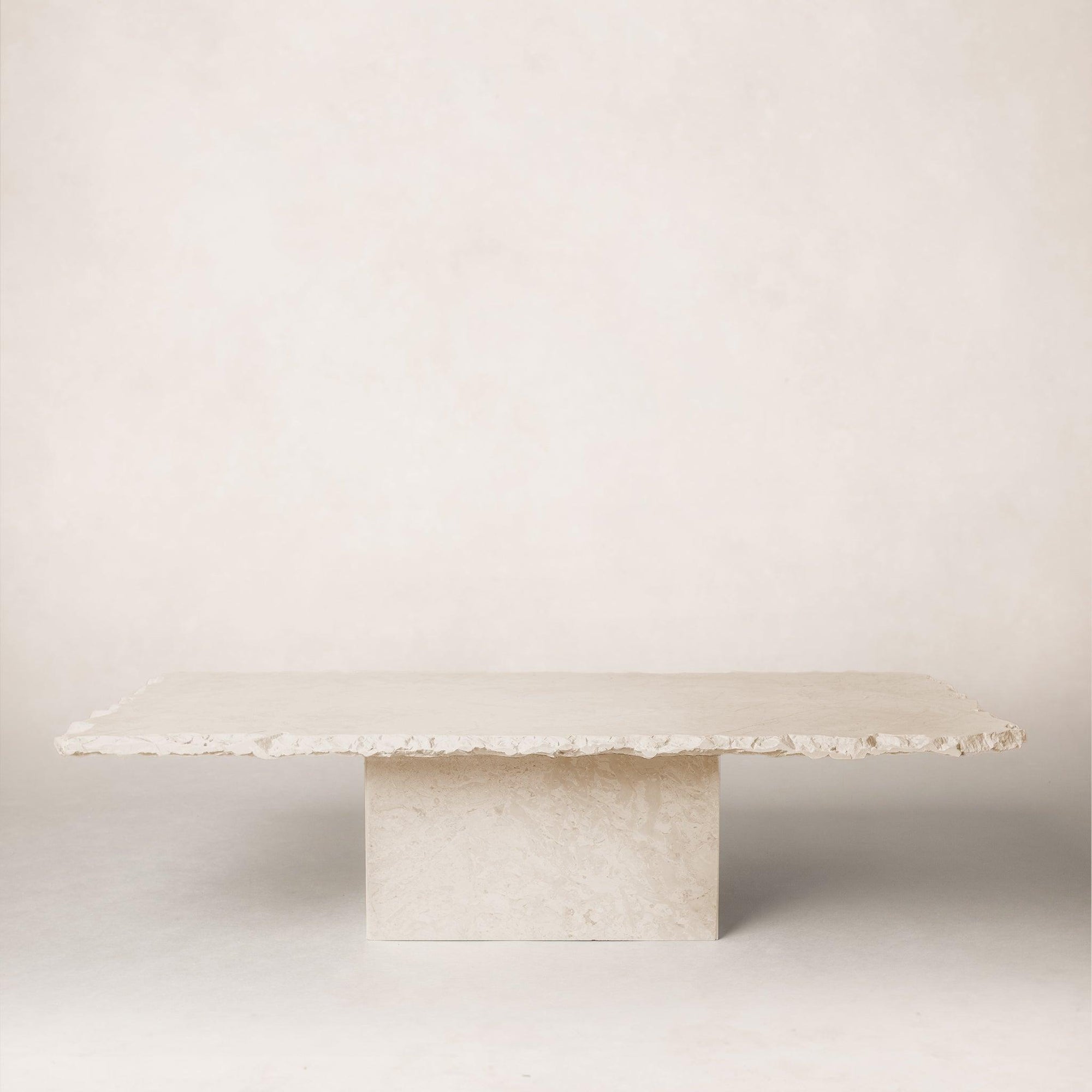 Sofita marble coffee table with minimal veining and sculptural pedestal base