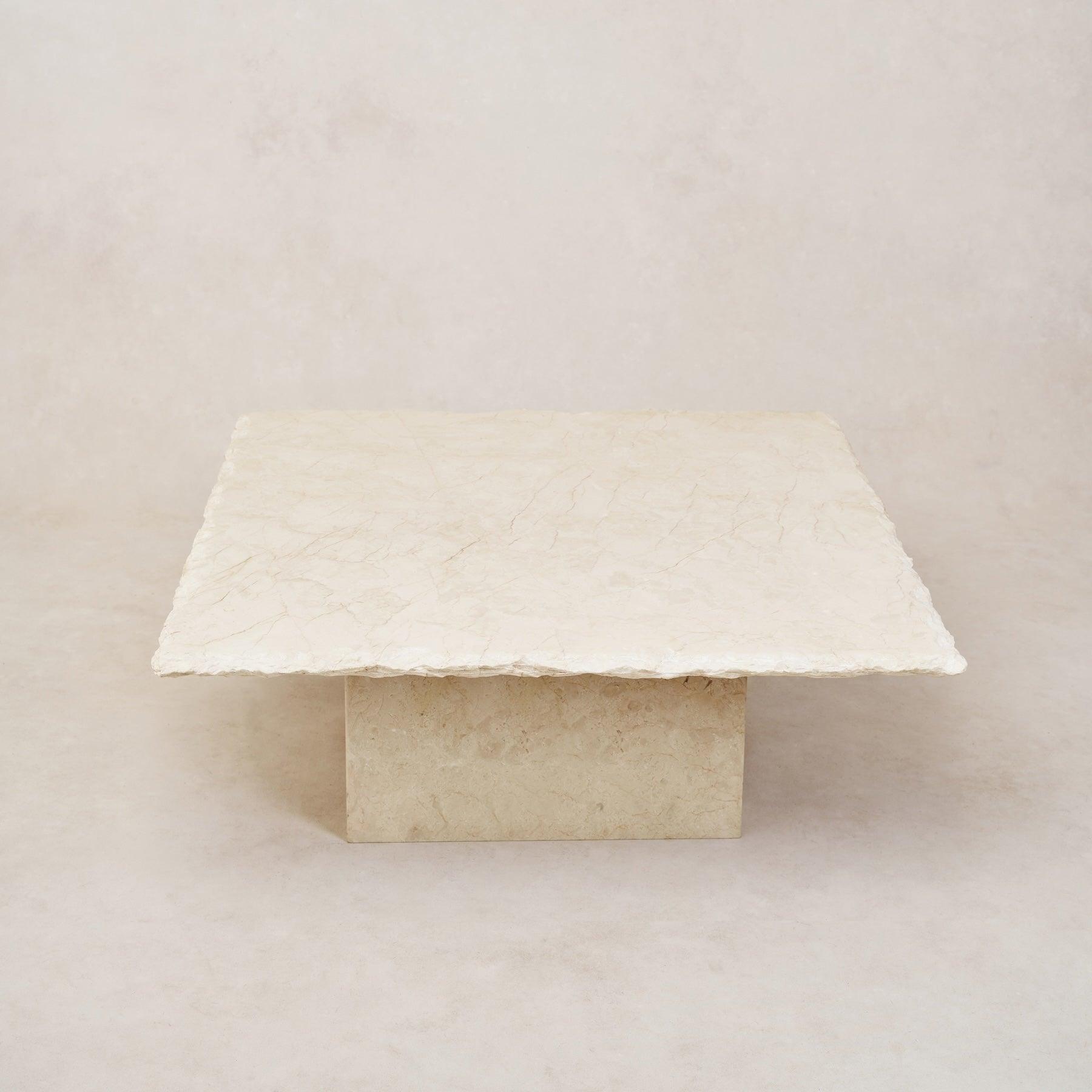 A square-shaped Sofita Marble coffee table with a smooth top surface and a visibly textured edge on a light background.