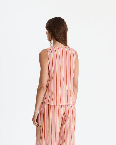 Back view showing the sleeveless top’s vertical stripes and straight hem above matching loose-fitting pants.