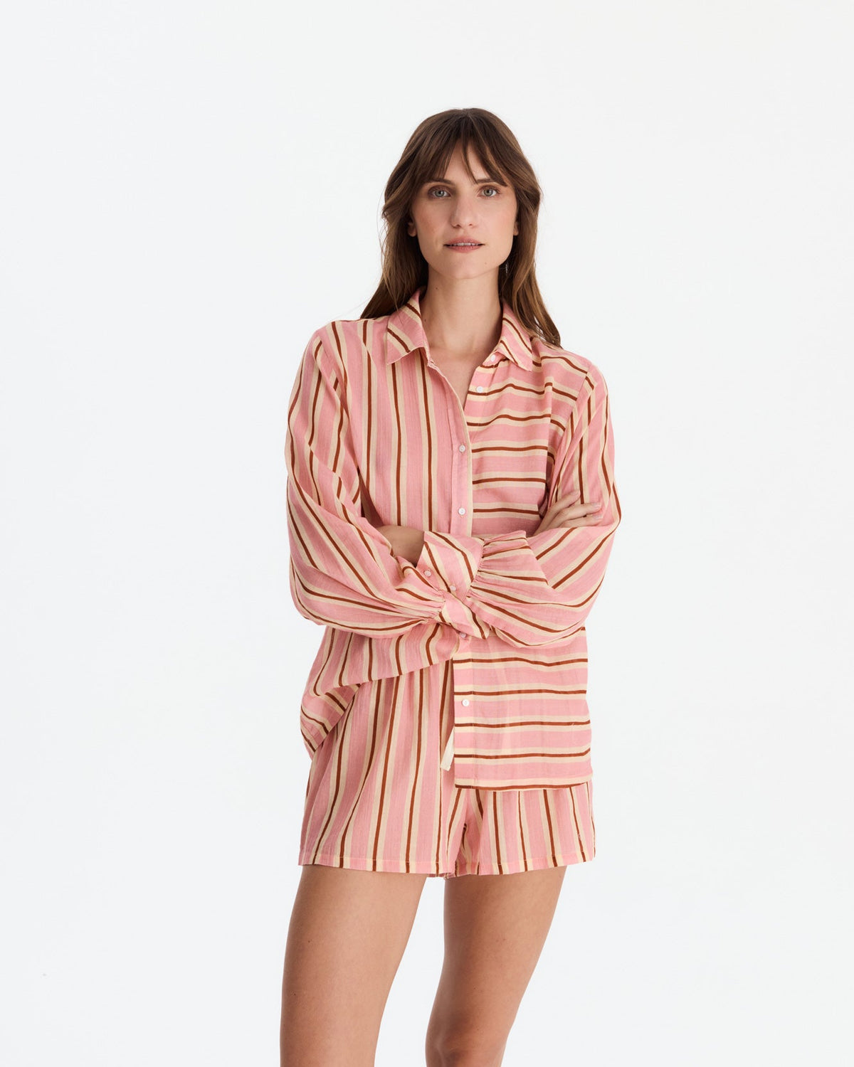 Model with arms loosely crossed, showing the shirt’s collar, buttons, and contrasting horizontal and vertical stripe panels.