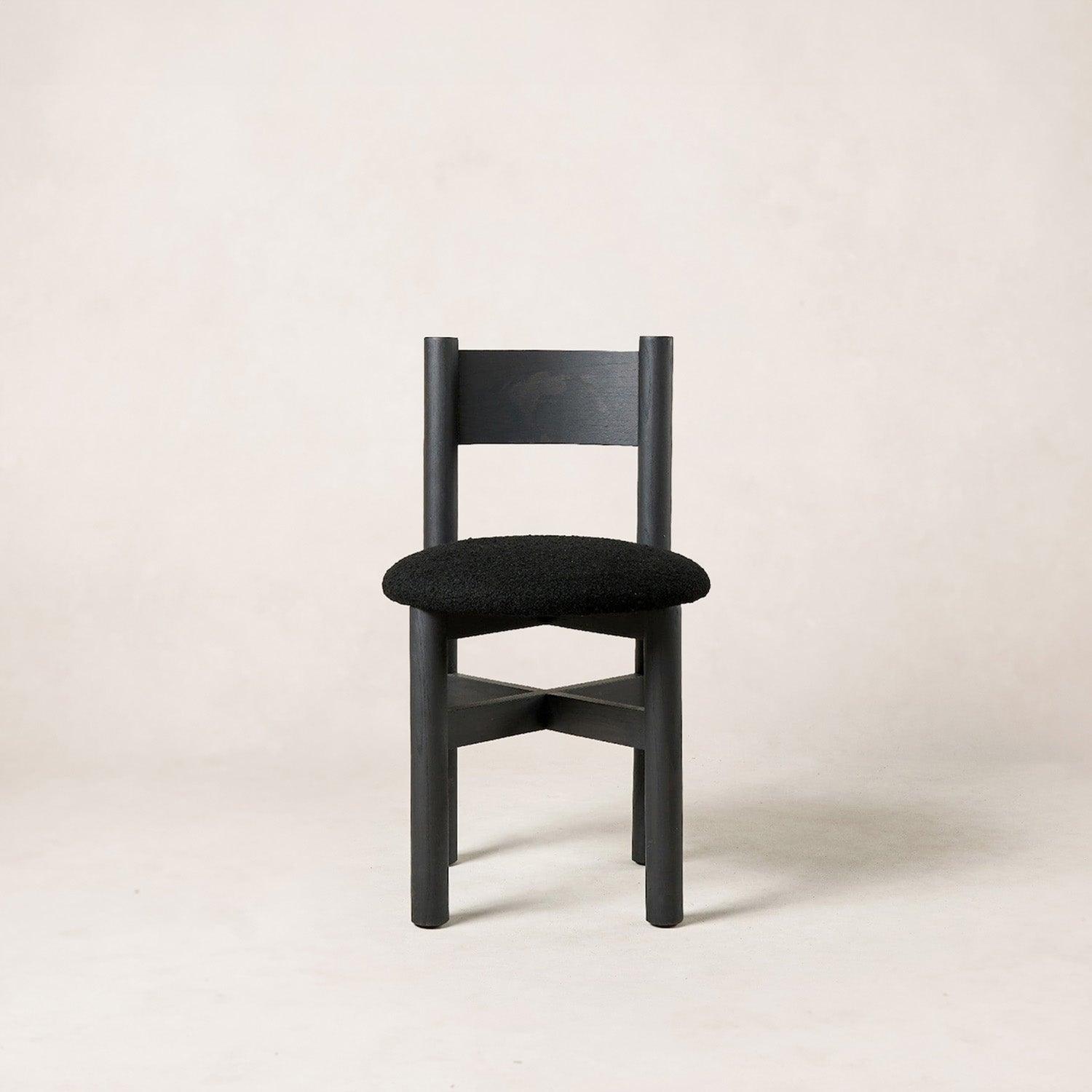 Teddy dining chair in black with solid white oak frame and bouclé upholstered seat