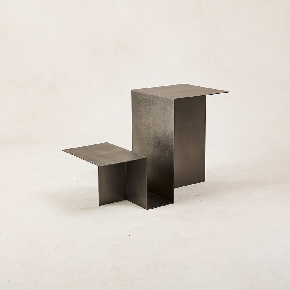 Hand-finished metal side table with soft reflective surface