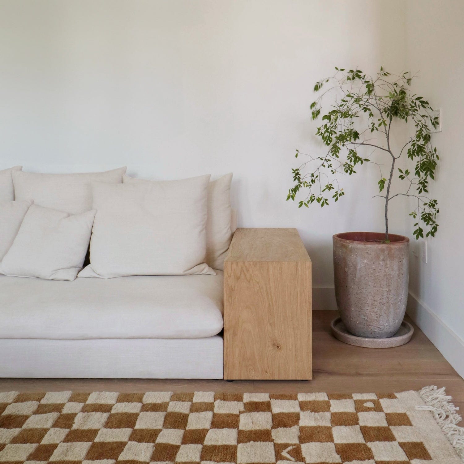 Topa Topa sofa showing integrated wood side table and linen cushions